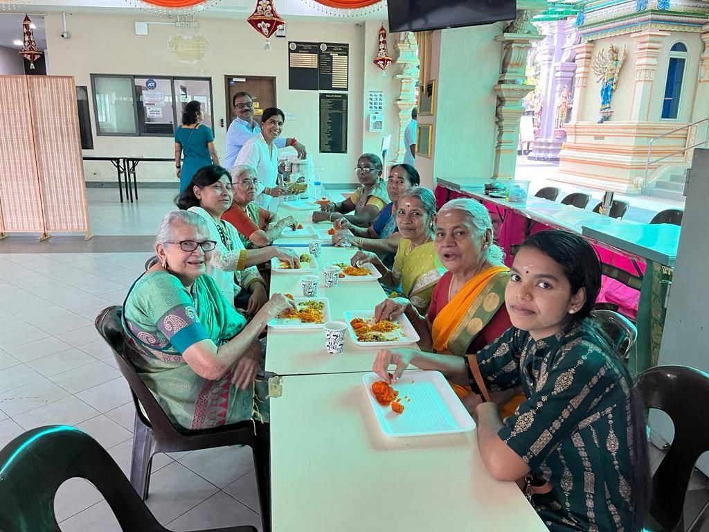 Pioneer members sharing a meal together around a table