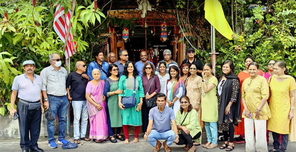 About twenty-five members standing together at the entrance to Sri Marathandavar Temple in Maran, Pahang.