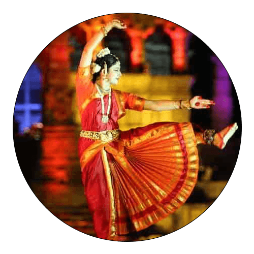 A classical dancer in red and gold costume, from the original Cultural Celebration section.