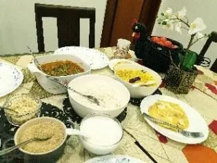 Sandhavai served with coconut milk and savoury accompaniments on a dining table