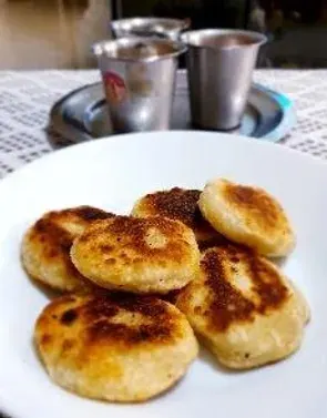 Opputtu on a plate beside two tumblers of coffee