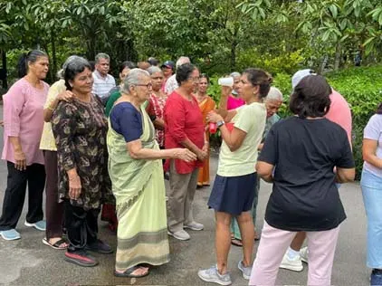 Senior members chatting together in the open air at the Botanic Gardens