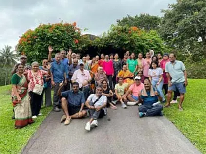 Senior members and helpers gathered for a group photograph on a Botanic Gardens path