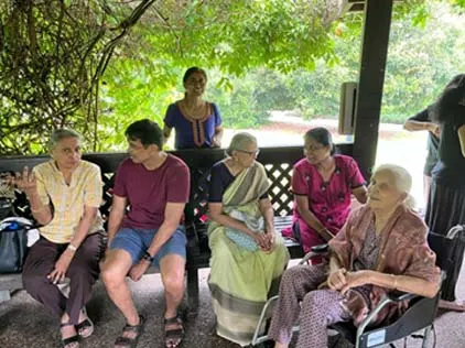 Senior members seated side by side in the pavilion
