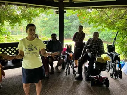 A member leading an activity for seated seniors, including wheelchair users